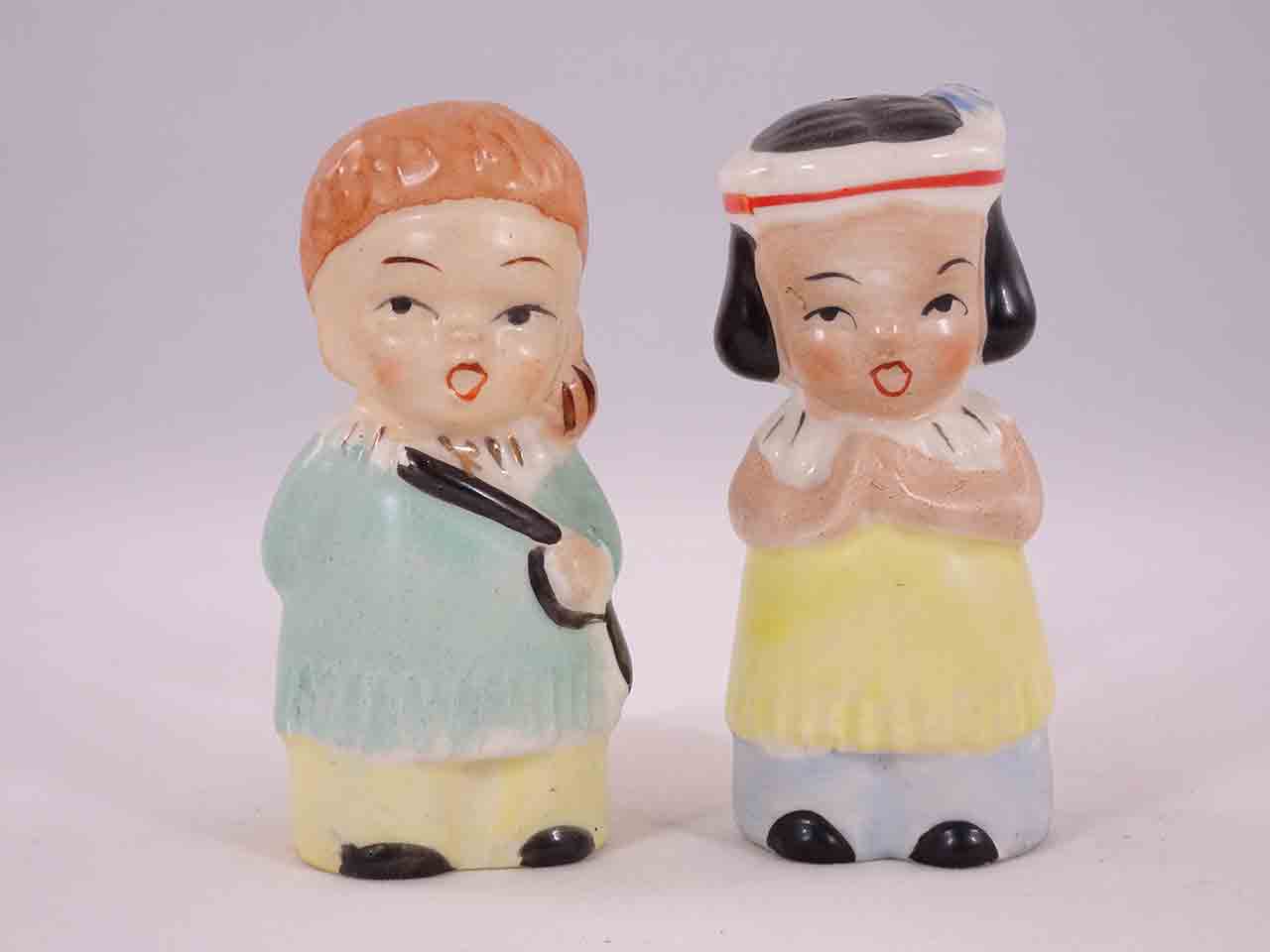 48621 Davy Crockett-like boys carrying guns with little Native American Indian girls salt and pepper shakers
