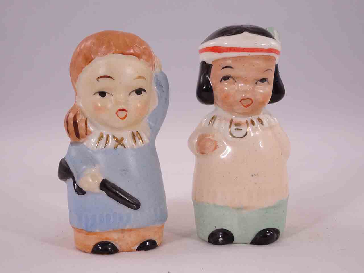 48623 Davy Crockett-like boys carrying guns with little Native American Indian girls salt and pepper shakers