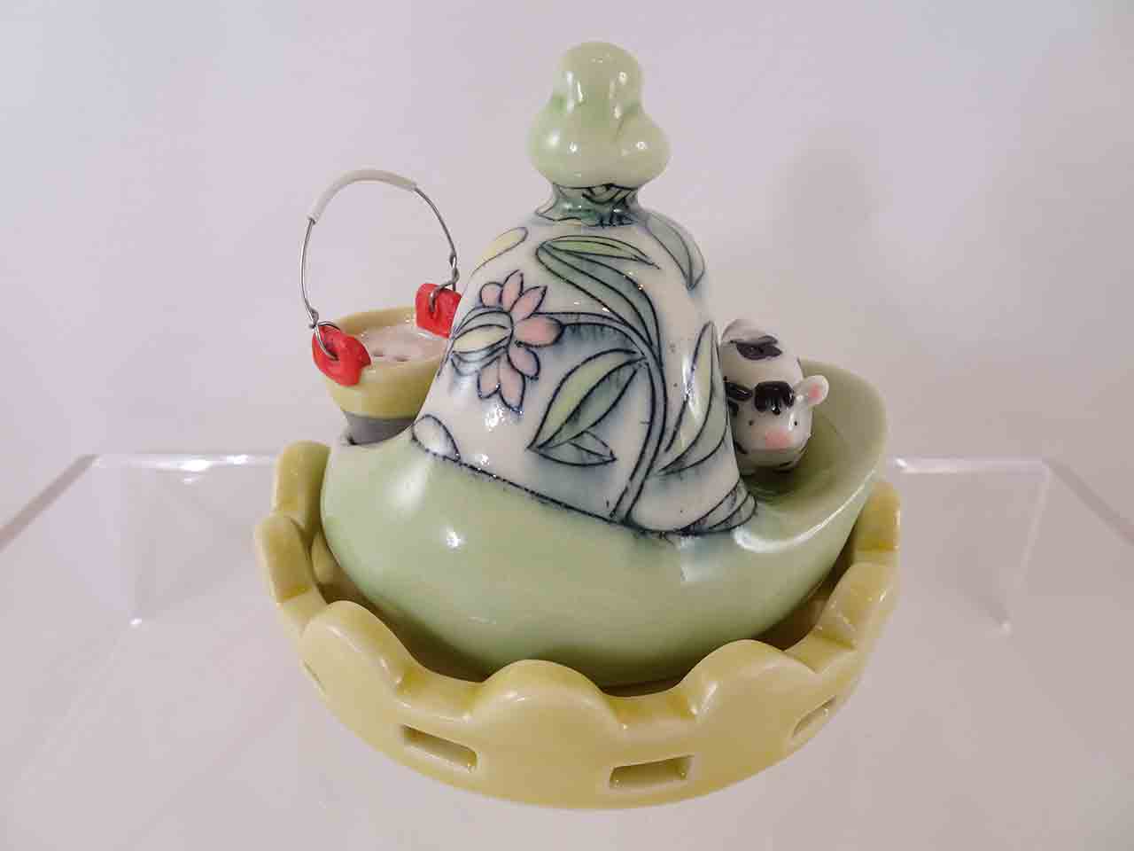 Chandra Debus cow in field with bucket salt and pepper shakers